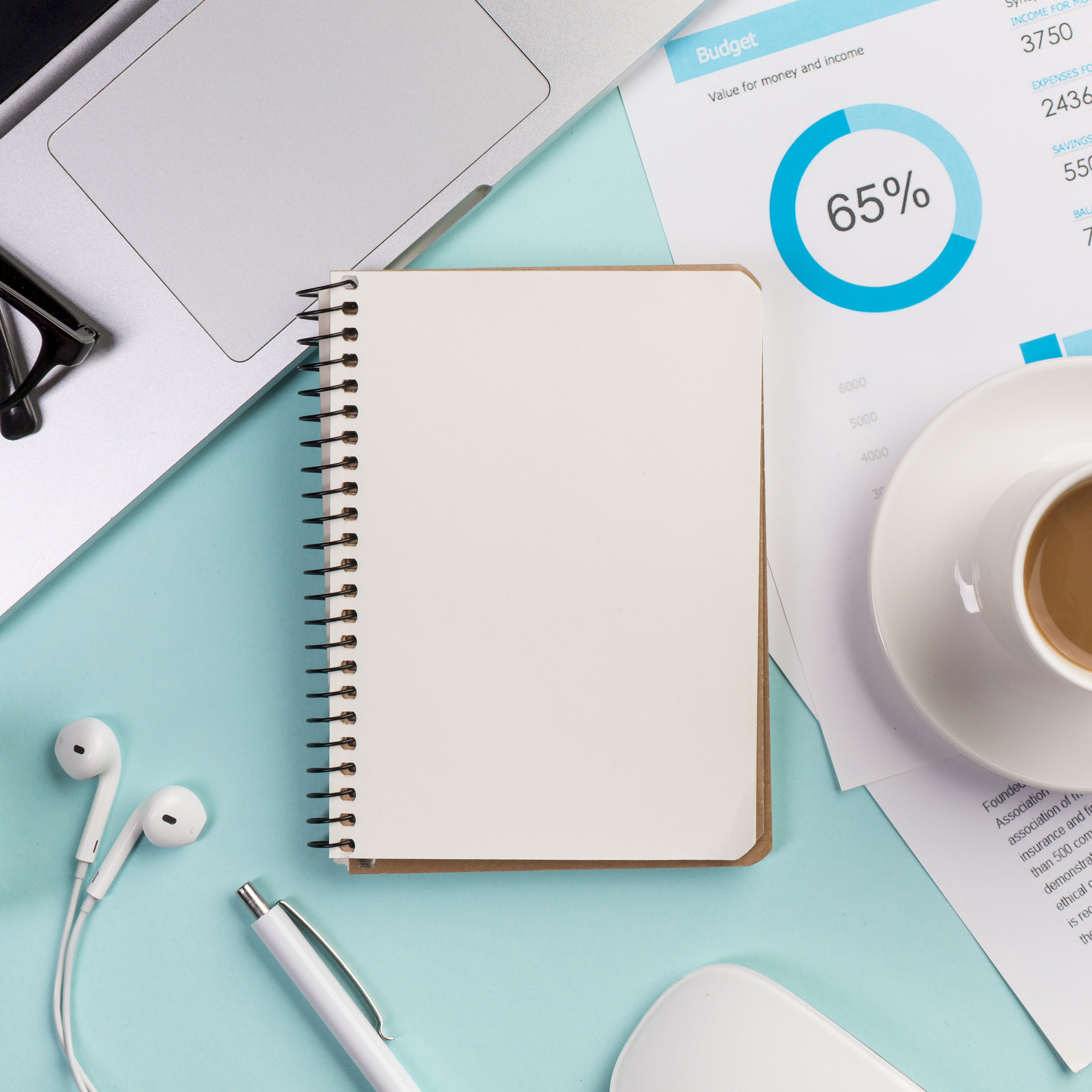 Budget planning notebook and materials on a desk